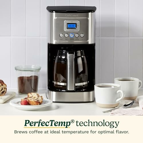 Coffee maker with PerfecTemp technology on kitchen counter with cups and pastries.