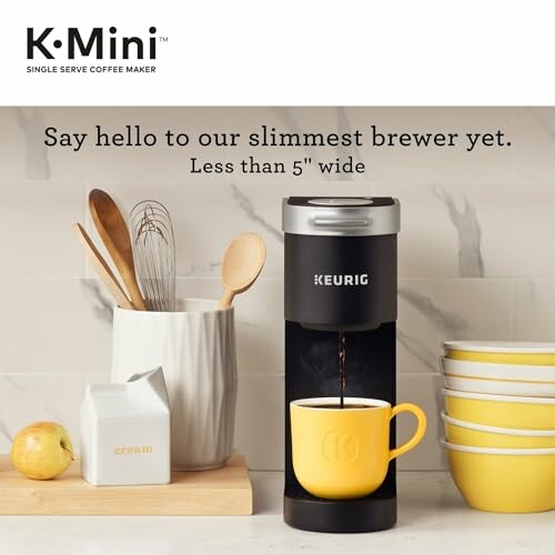 Keurig K-Mini coffee maker with cup and kitchen items